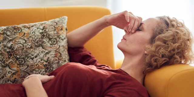 Woman on couch with headache