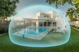 large home with a pool being protected form mosquitoes by a mosquito repellent system. 