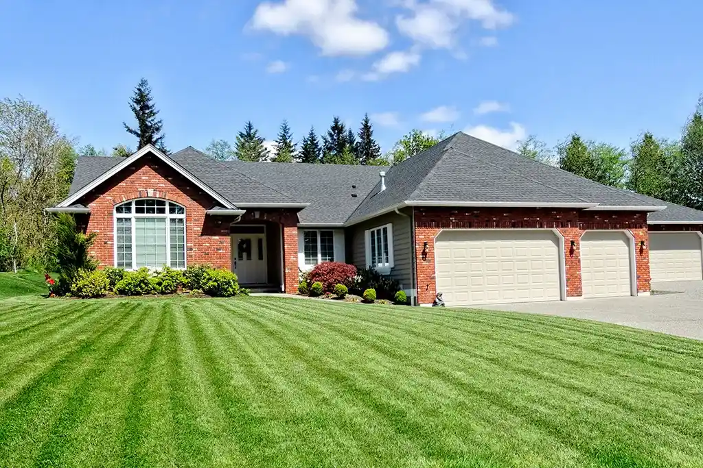 Modern brick home with freshly mowed grass